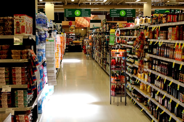 Fully-stocked shelf in a grocery store. 